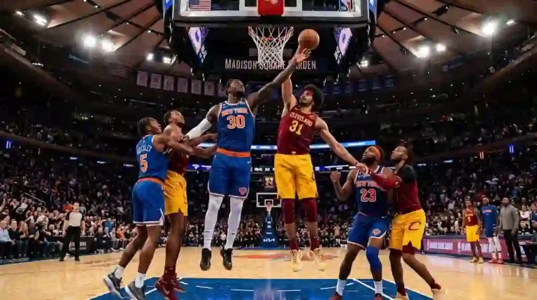 New York Knicks player jumping under the rim for a rebound against a Cleveland Cavaliers player in a high-energy NBA game at Madison Square Garden.